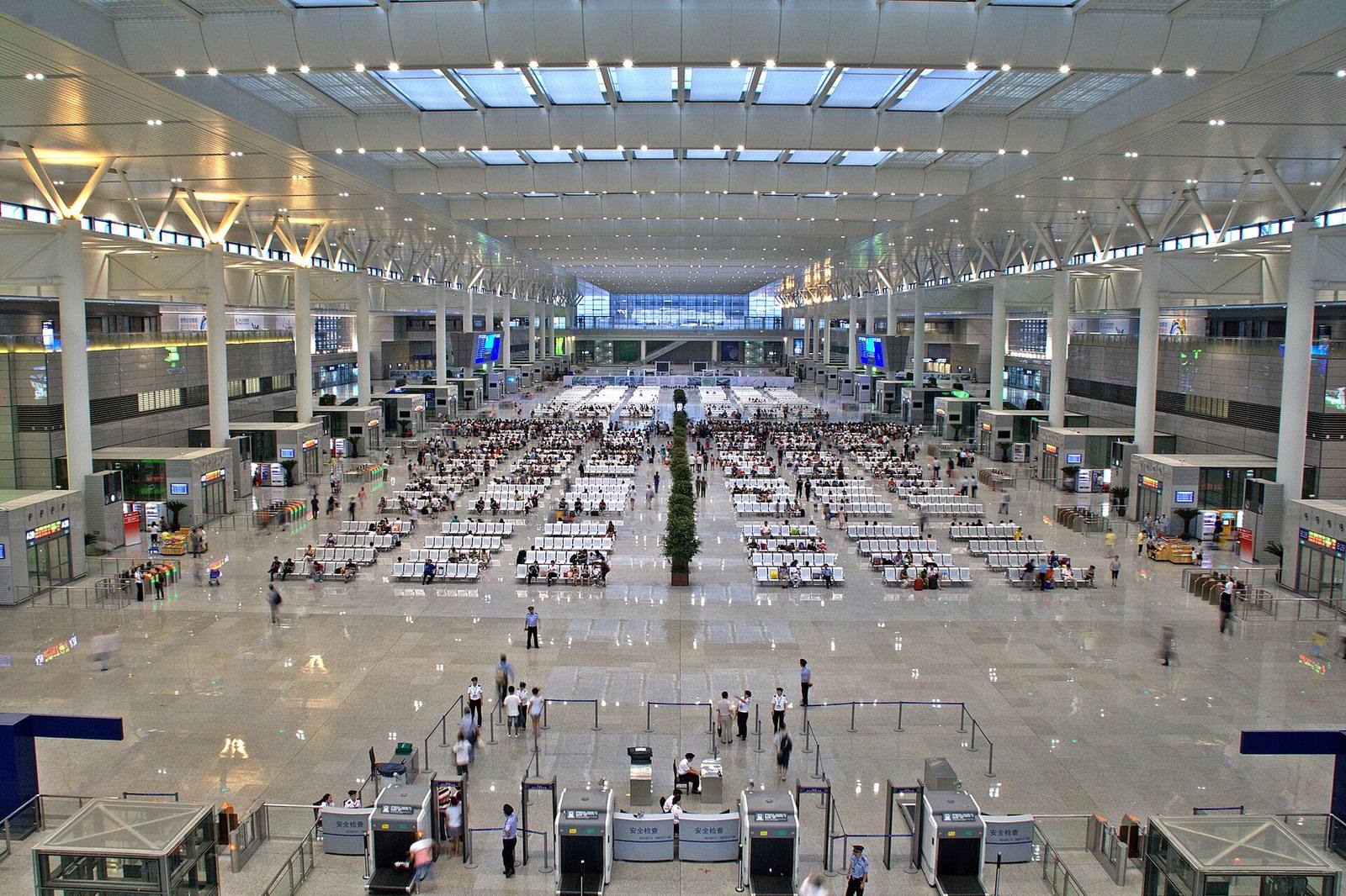 The vast departure hall of Shanghai Hongqiao station filled with rows of waiting passengers