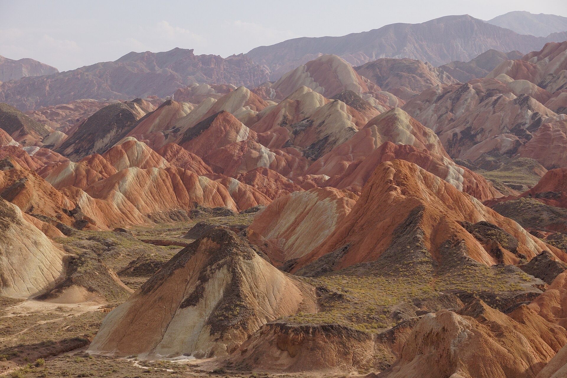 Layered ridges of red, ochre and cream rock in the Zhangye Danxia landform