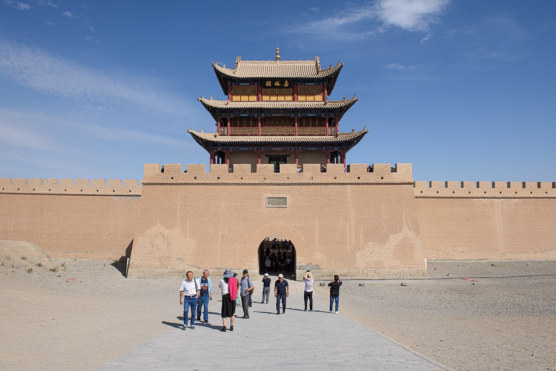 The Ming-dynasty gate tower and rammed-earth walls of Jiayuguan fort under a blue sky