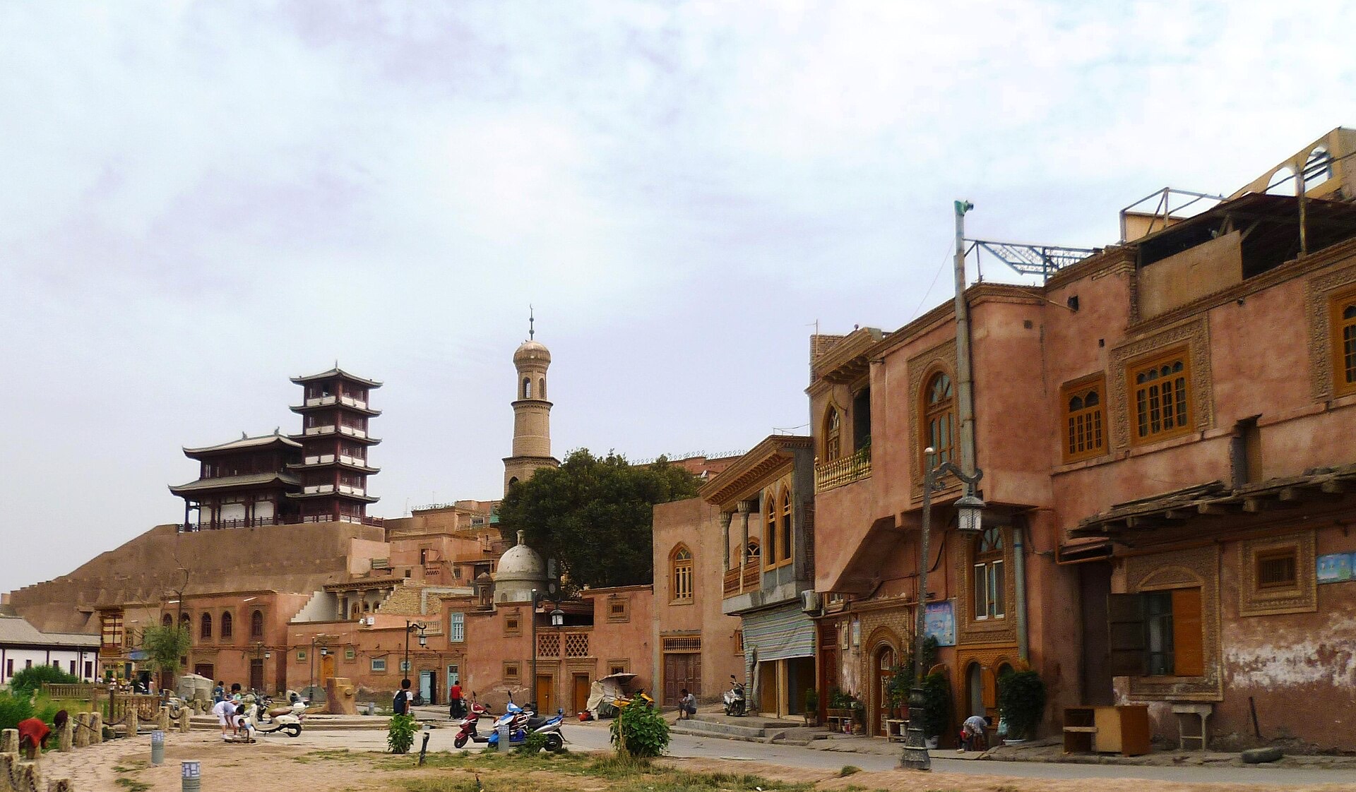 Traditional mud-brick houses with carved wooden balconies and a minaret in Kashgar's old town