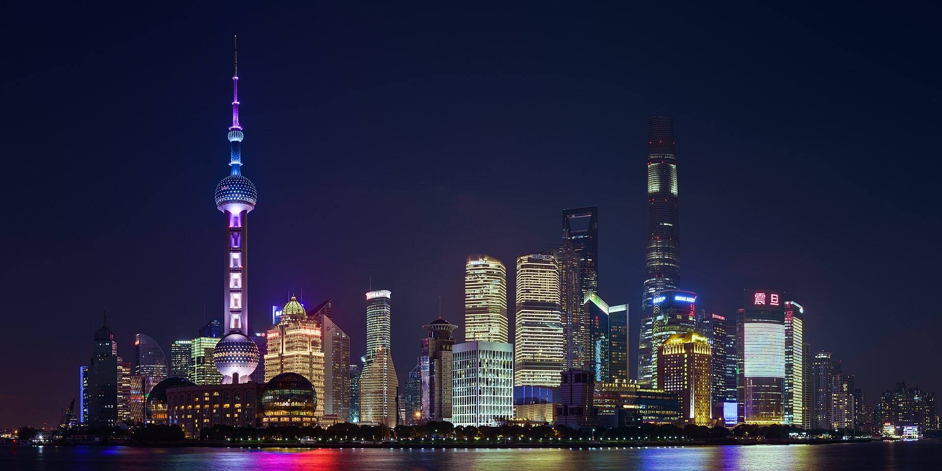 The Lujiazui skyline lit up at dusk, seen across the river from the Bund