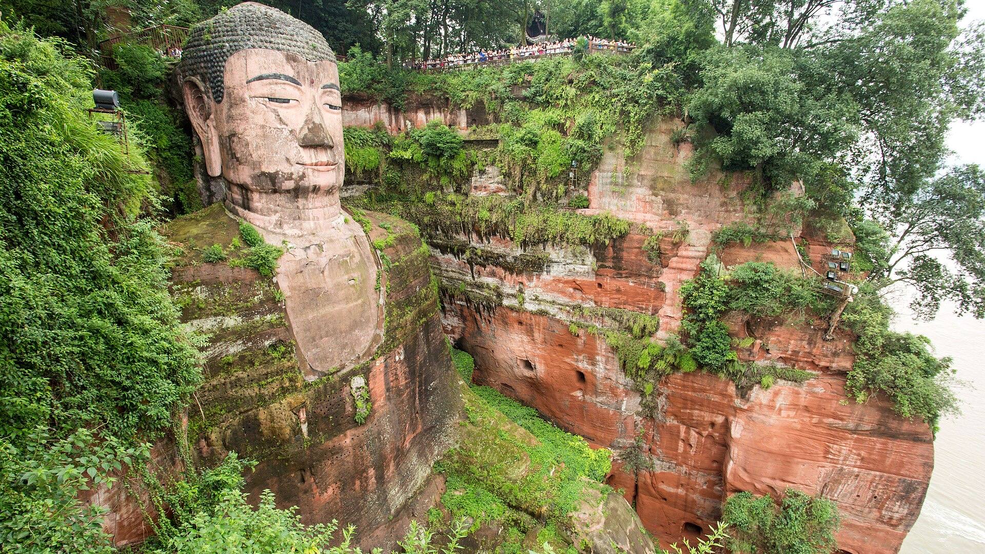The 71-metre Leshan Giant Buddha carved into the red river cliff